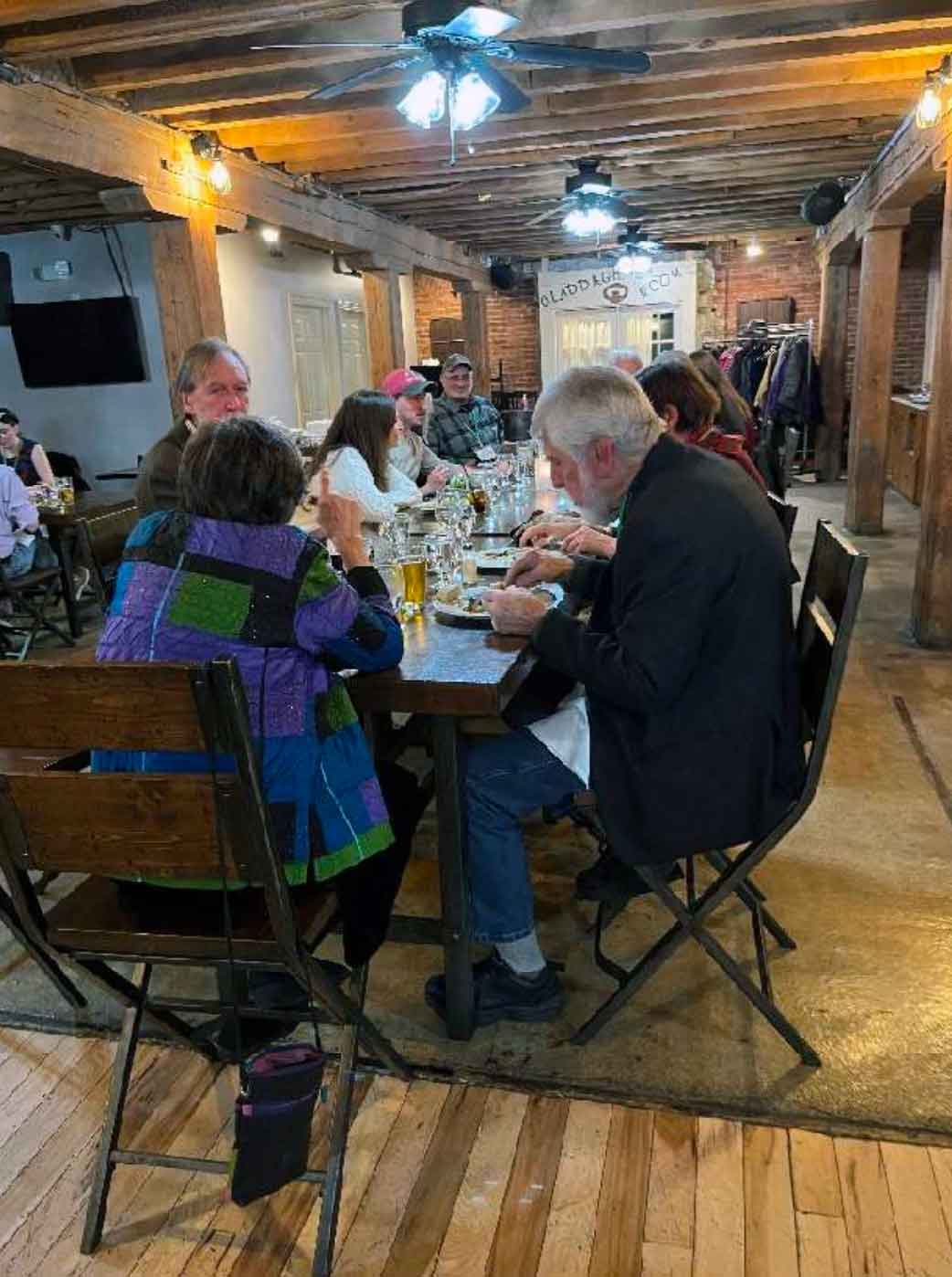 People seated people at a table eating.